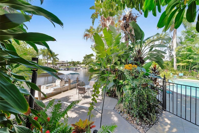 exterior space with a community pool and a water view