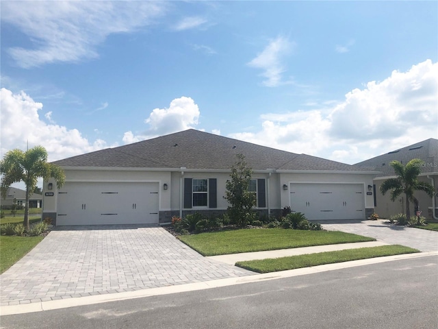 ranch-style home with a garage and a front yard