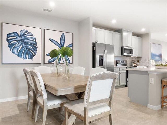 dining room featuring light tile patterned floors