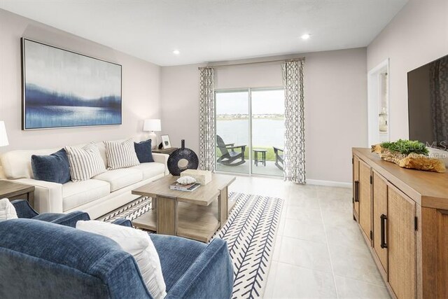 tiled living room featuring a water view