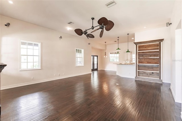 unfurnished living room featuring ceiling fan and dark wood-type flooring