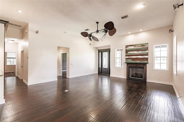 unfurnished living room featuring ceiling fan and dark hardwood / wood-style flooring