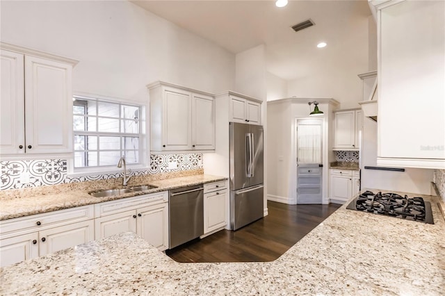 kitchen featuring white cabinets, appliances with stainless steel finishes, dark wood-type flooring, and sink