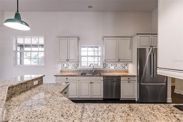 kitchen featuring light stone countertops, appliances with stainless steel finishes, sink, and white cabinetry