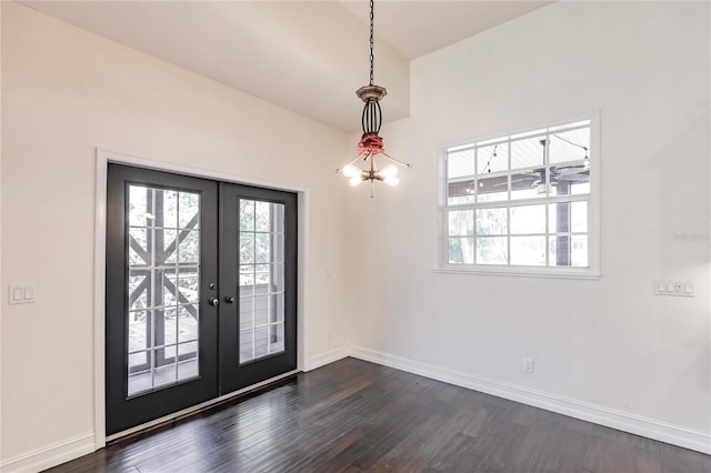 entryway featuring french doors, a notable chandelier, and dark wood-type flooring