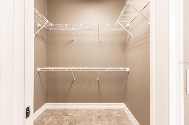 spacious closet featuring tile patterned floors