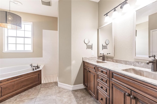 bathroom featuring vanity, tile patterned floors, and a tub