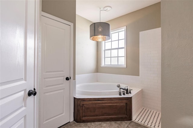 bathroom featuring plus walk in shower and tile patterned flooring