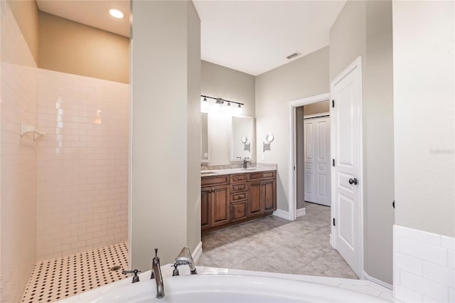 bathroom with tile patterned floors, independent shower and bath, and vanity