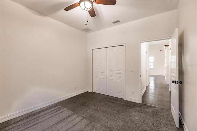 unfurnished bedroom with ceiling fan, a closet, and dark hardwood / wood-style floors