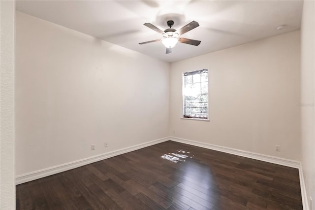 spare room with ceiling fan and dark hardwood / wood-style floors