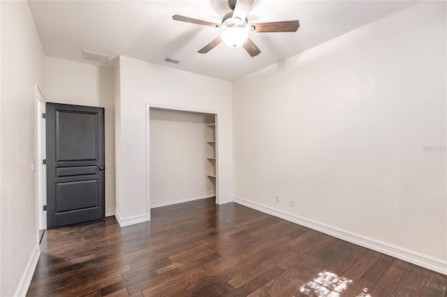 unfurnished bedroom with dark hardwood / wood-style flooring, ceiling fan, and a closet