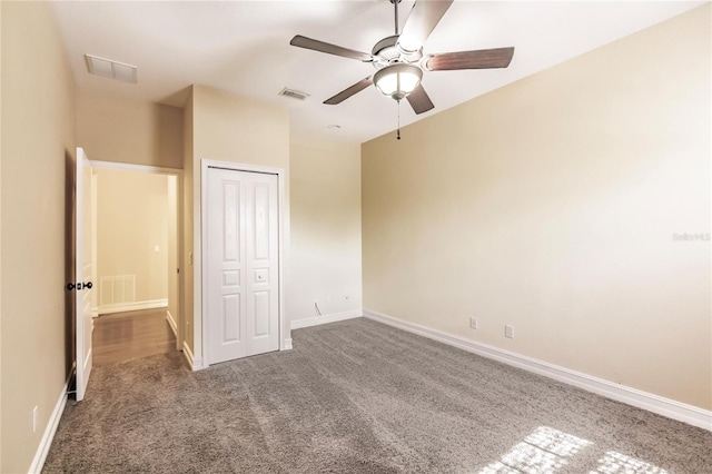 unfurnished bedroom featuring ceiling fan, a closet, and carpet