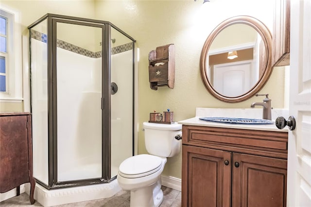 bathroom with walk in shower, tile patterned flooring, vanity, and toilet