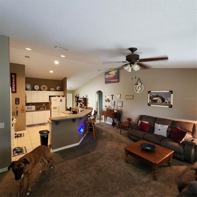 carpeted living room featuring lofted ceiling, ceiling fan, and a textured ceiling