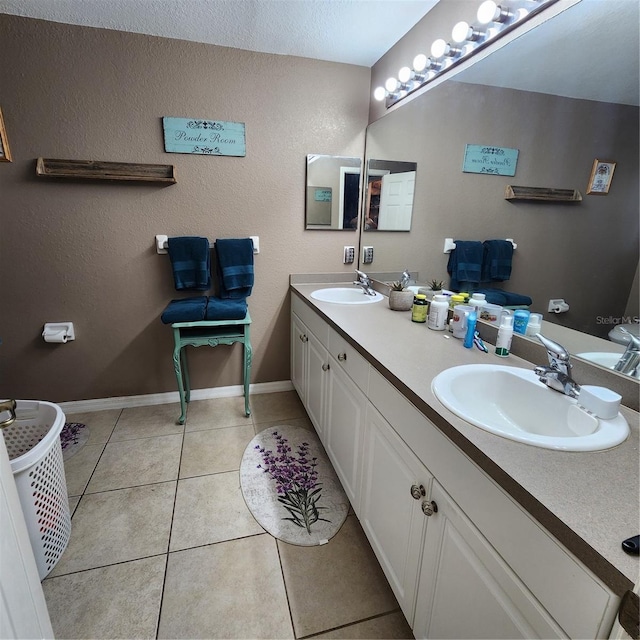 bathroom featuring tile patterned flooring, vanity, and a textured ceiling