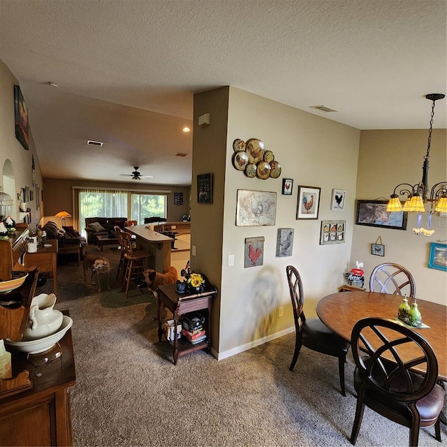 dining area with a textured ceiling, carpet flooring, and ceiling fan