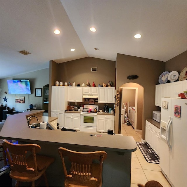 kitchen with white cabinetry, white appliances, a spacious island, and light tile patterned floors