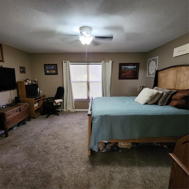 carpeted bedroom featuring ceiling fan and a textured ceiling