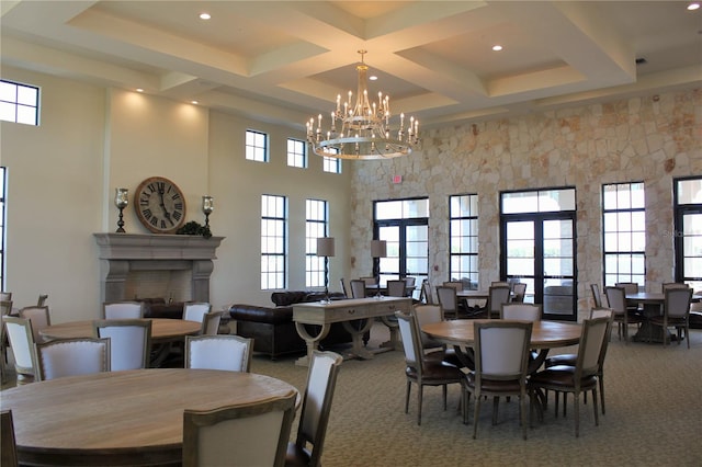 dining room with an inviting chandelier, coffered ceiling, french doors, and carpet flooring