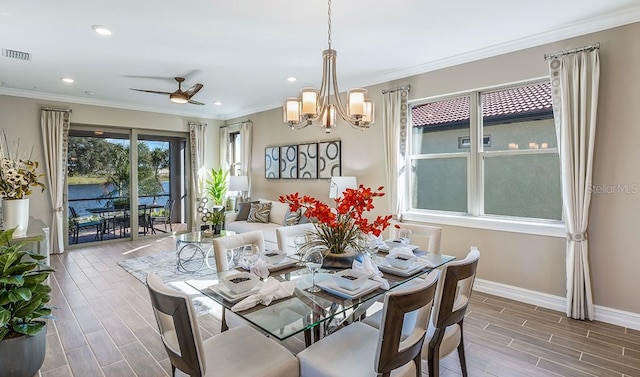 dining area featuring ornamental molding and ceiling fan with notable chandelier