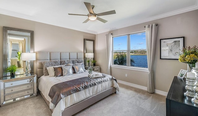 bedroom featuring light carpet, crown molding, ceiling fan, and a water view