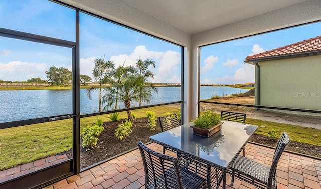 sunroom / solarium featuring a water view