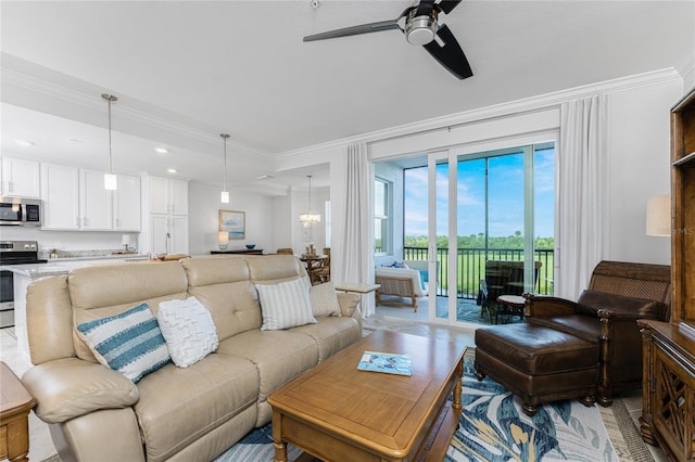 living room featuring crown molding and ceiling fan with notable chandelier