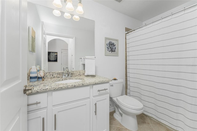 bathroom featuring a shower with curtain, tile patterned flooring, toilet, and vanity