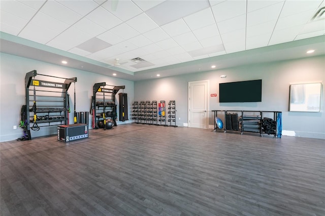 workout area featuring wood-type flooring and a drop ceiling