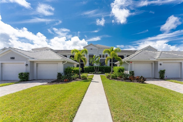 view of front facade with a front yard and a garage