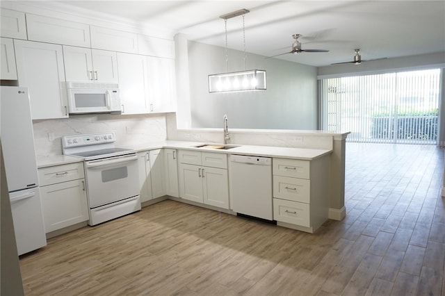 kitchen with white appliances, pendant lighting, kitchen peninsula, sink, and ceiling fan