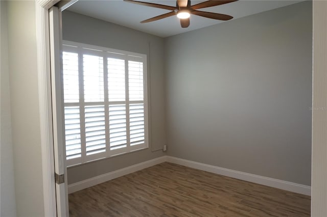 empty room featuring dark wood-type flooring and ceiling fan