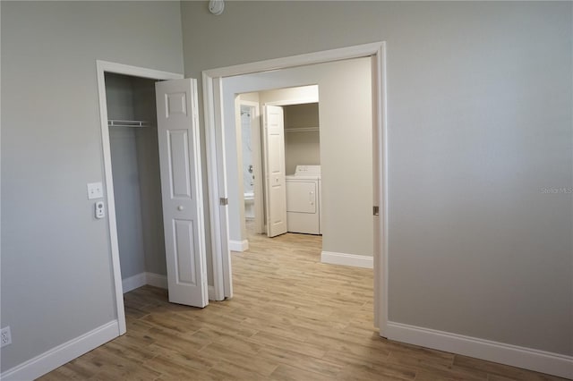 interior space featuring a closet, independent washer and dryer, and light hardwood / wood-style floors