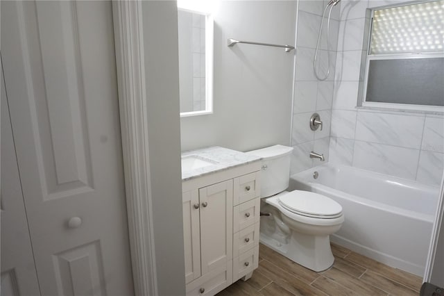 full bathroom featuring vanity, toilet, wood-type flooring, and washtub / shower combination