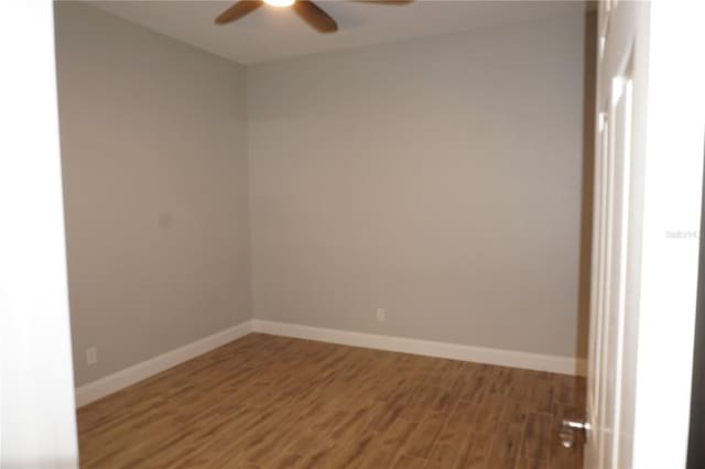 empty room with hardwood / wood-style flooring and ceiling fan