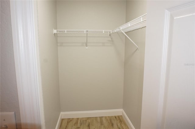 spacious closet featuring hardwood / wood-style flooring