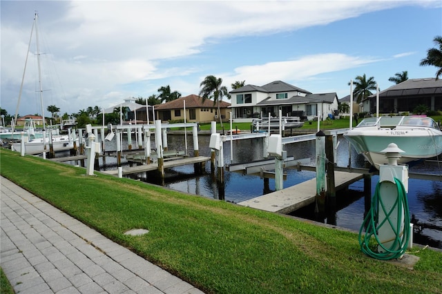 dock area with a water view and a yard