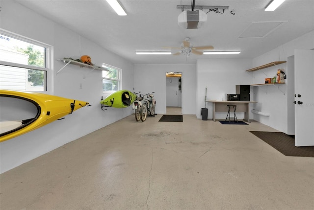 garage with a garage door opener and ceiling fan