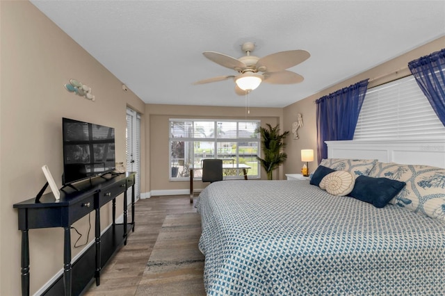 bedroom with ceiling fan and wood-type flooring