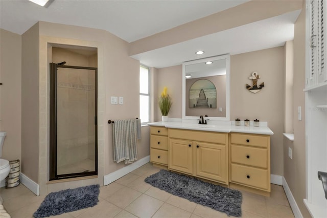 bathroom featuring vanity, toilet, tile patterned floors, and a shower with shower door