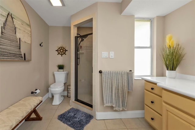 bathroom featuring a shower with door, plenty of natural light, toilet, and vanity