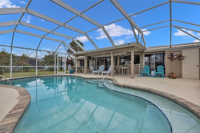 view of swimming pool with ceiling fan, a patio area, and glass enclosure