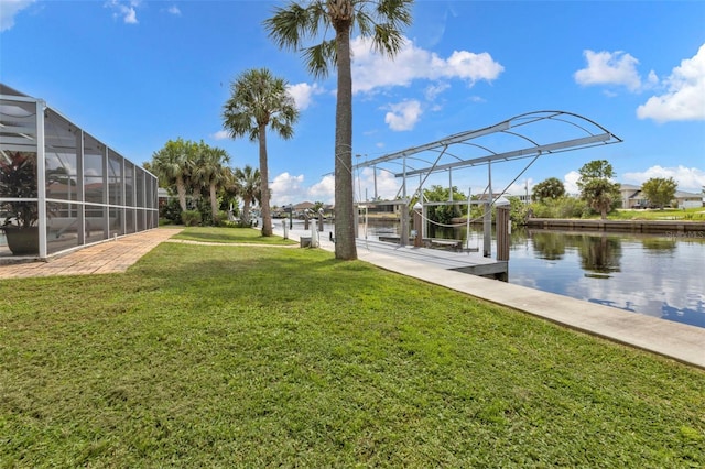 view of yard featuring a water view, glass enclosure, and a boat dock