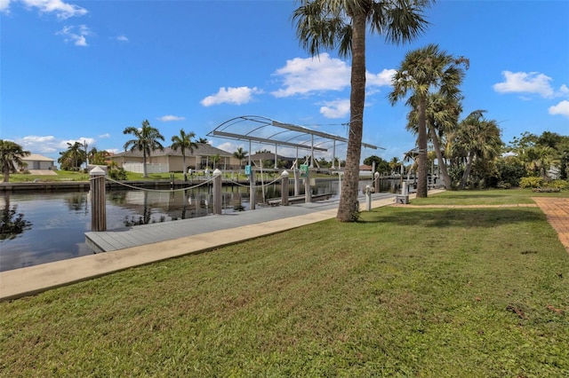 dock area with a water view and a lawn