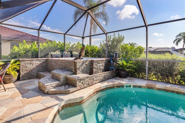 view of swimming pool with a lanai and a patio