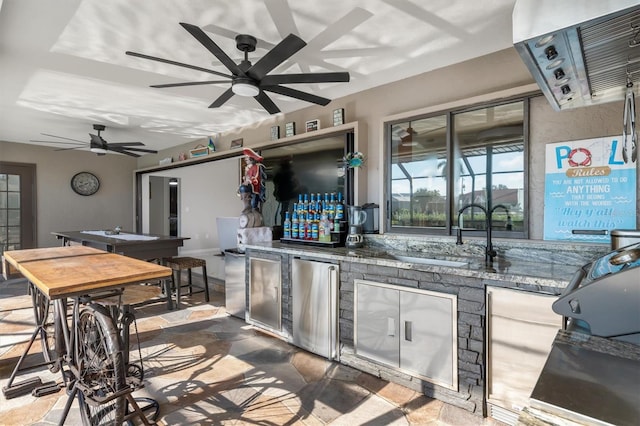 interior space featuring a wall mounted air conditioner, an outdoor kitchen, and sink