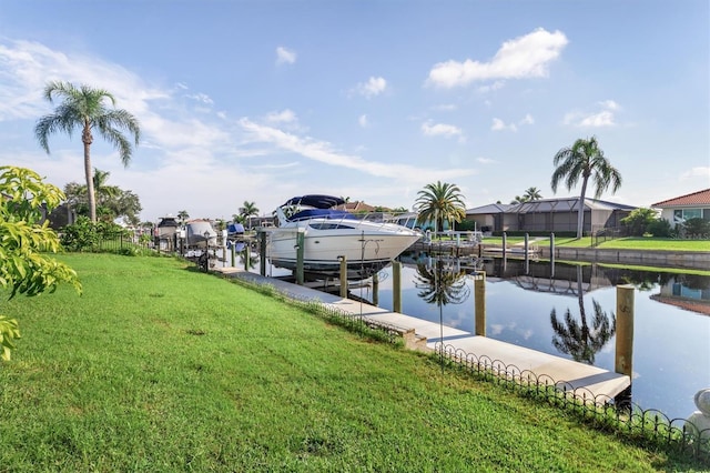 view of dock with a yard and a water view