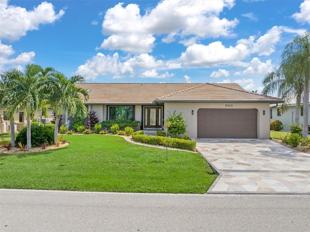 ranch-style home featuring a front yard and a garage