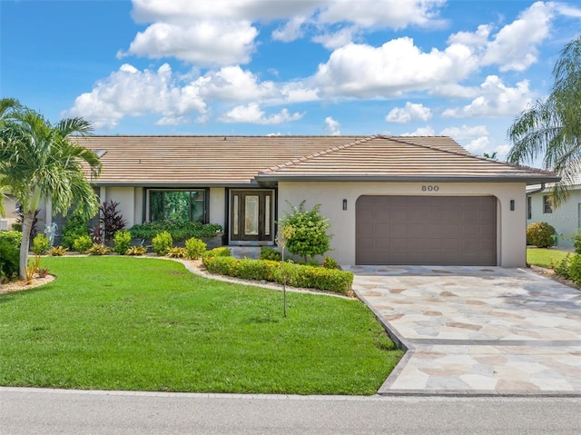 single story home with a garage and a front yard